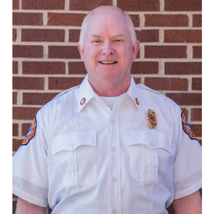 Doug Lutes Headshot with Brick Background